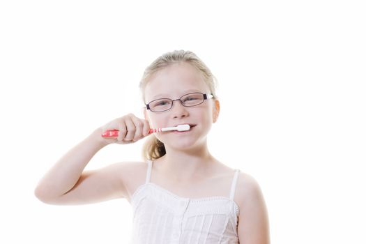 preteen girl brushing her teeth isolated on white