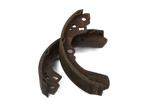 Old brake pads drum brake, isolated on a white background
