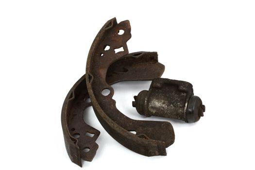Old brake pads and cylinder brake drum, isolated on a white background