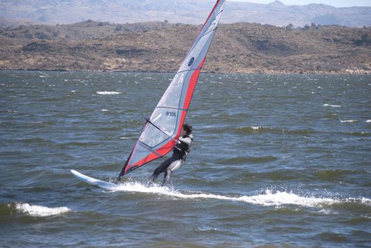 
SAN LUIS - ARGENTINA - JULIO 24: A young person practices windsurf in the lake of the dock Florida in Argentinean the 24 of Julio of 2011
