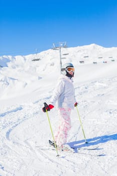 Young girl in ski outfit in the Zillertal Arena, Austria. Vertical view