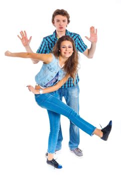 Smiling teenager boy indulge his pretty girlfriend. Isolated on white background.