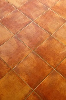 Closeup of square terracotta ceramic tile floor background