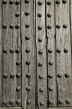 Background of old wooden door with metal studs