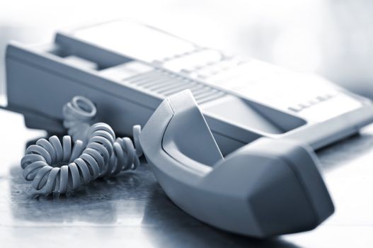 Telephone handset off the hook on desk