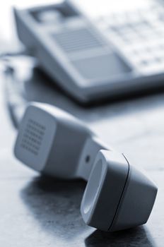 Telephone handset off the hook on desk