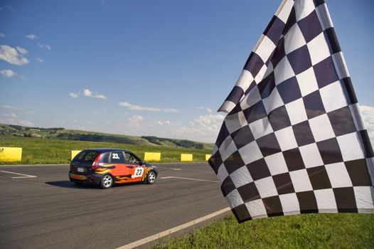 Auto racing checkered flag on a background of the  blue sky.