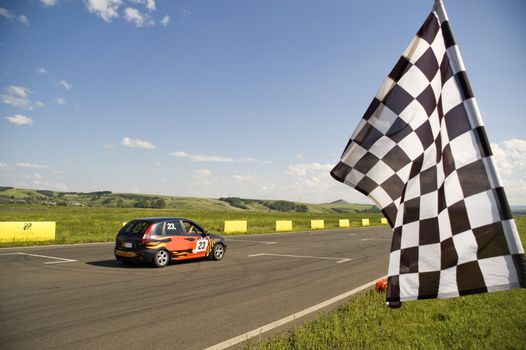 Auto racing checkered flag on a background of the  blue sky.