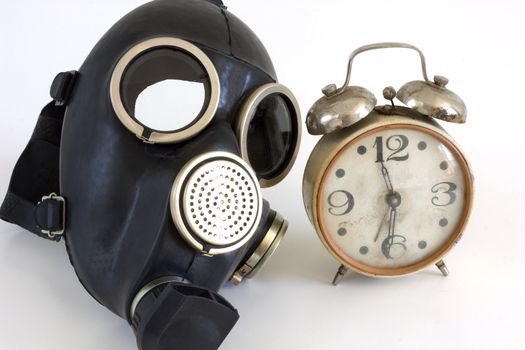 The Gas mask and old watch on white background.