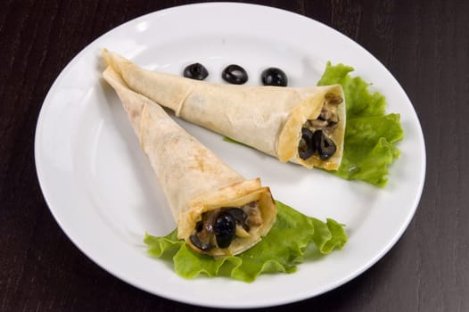 Pancakes with mushrooms, olives and green salad.