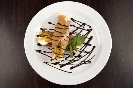 Pancakes with fruit, whipped cream in chocolate.