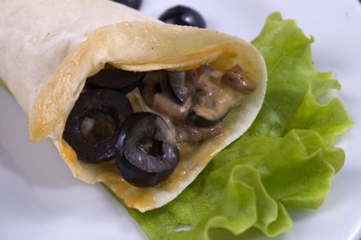 Pancakes with mushrooms, olives and green salad.