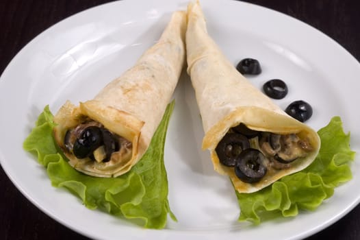 Pancakes with mushrooms, olives and green salad.