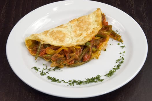 Pancakes with vegetables on a white plate.