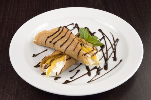 Pancakes with fruit, whipped cream in chocolate.