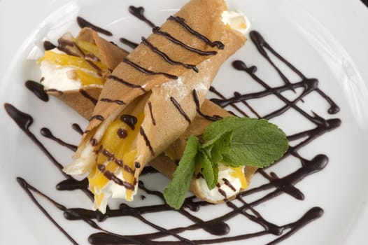 Pancakes with fruit, whipped cream in chocolate.