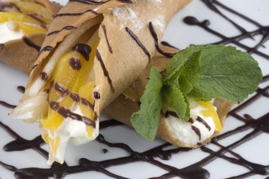
Pancakes with fruit, whipped cream in chocolate.