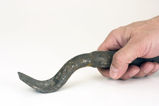 The iron tool in a hand on a white background.