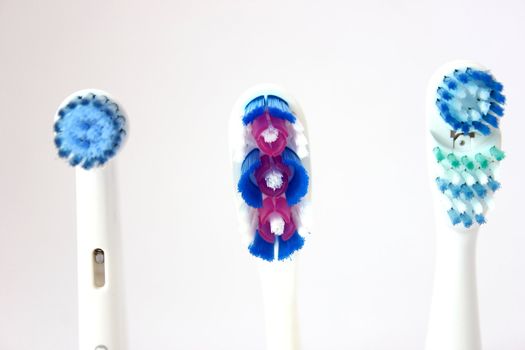 3 different types of tooth brush heads on an isolated background.