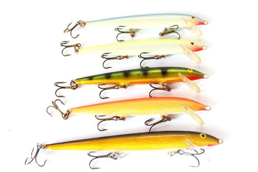 Isolated set of the same fishing lure in different varieties.