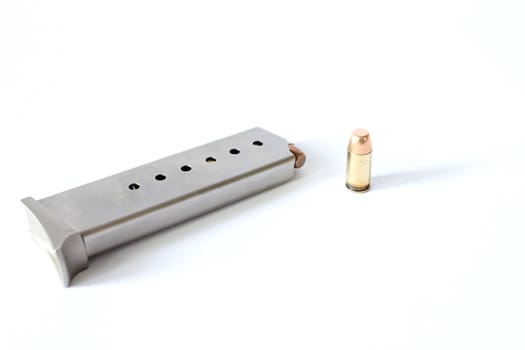 Isolated 380 caliber bullet with clip