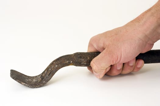 The iron tool in a hand on a white background.