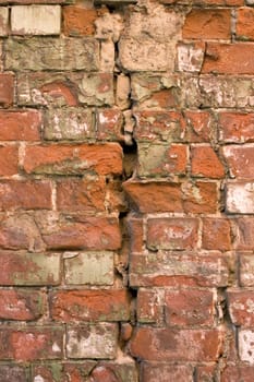 The damaged brick wall.
