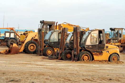 Heavy duty construction machinery on a construction site or roadworks where earth moving is taking place