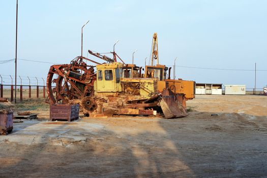 Large industrial excavators parked at the side of a road on a construction site or roadworks