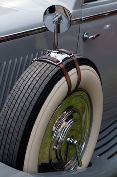 great oldtimer vintage car detail: mirror mounted on spare tire