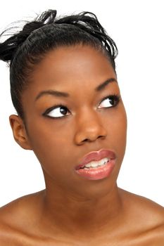 A studio close-up of a lovely young black woman looking up toward frame right.