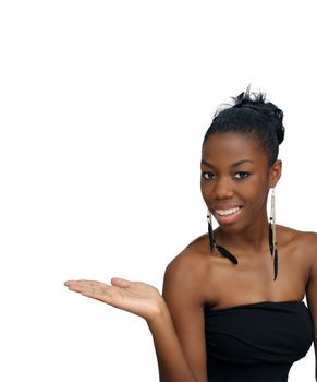 A lovely young black hostess holding her right hand out, palm up.  Isolated on a white background with generous copyspace.