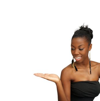 A lovely young black hostess holding her right hand out, palm up.  Isolated on a white background with generous copyspace.