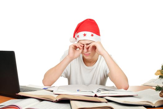 tired and sleepy student in santa's hat after hard work for exam. isolated on the white background