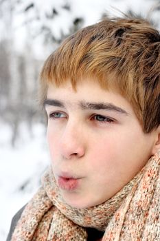 teenage boy portrait on hard frost in the winter forest