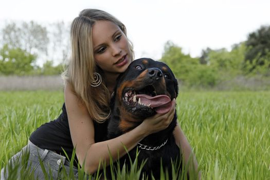 portrait of a purebred rottweiler and young woman