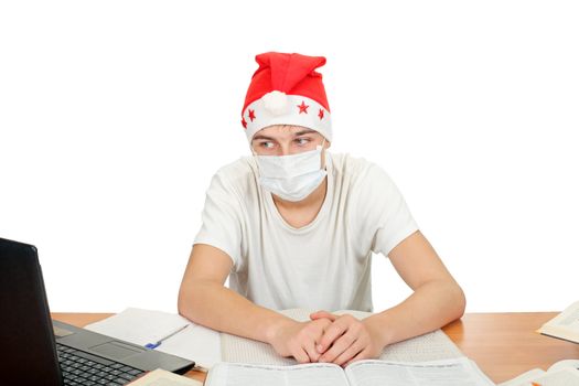 sick and sad student in santa's hat and flu mask.isolated on the white background