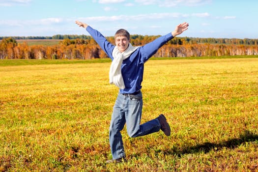 happy teenager running on the autumn field