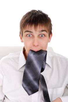 Surprised Teenager hold the Tie in his Mouth. Isolated on the white Background