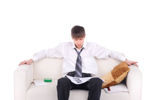 Teenager reads the book on the Sofa. Isolated on the white