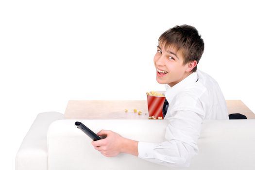 Cheerful Teenager sitting on the Sofa with Remote Control and Popcorn