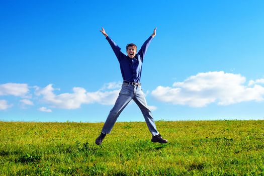 Happy Young Man Jumping in the Summer Field