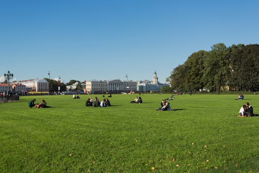 People enjoying a sunny day in the park of Saint-Petersburg