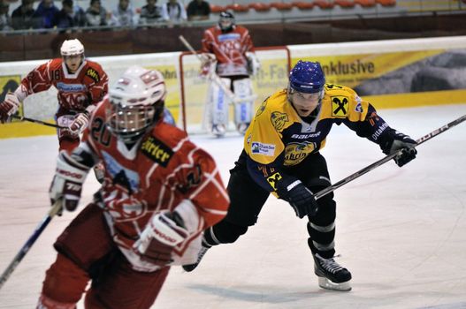 ZELL AM SEE; AUSTRIA - AUG 30: Austrian National League. Volker Keidel number 77 of Zell am See (blue jersey) is backchecking on a player of KAC II. Game EK Zell am See vs KAC II (Result 2-3) on August 30, 2011 in Zell am See.