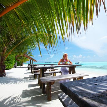 woman in a tropical cafe