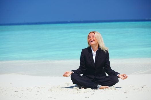 yoga business woman in lotus pose on the beach