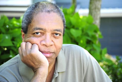 African American male posing outside.