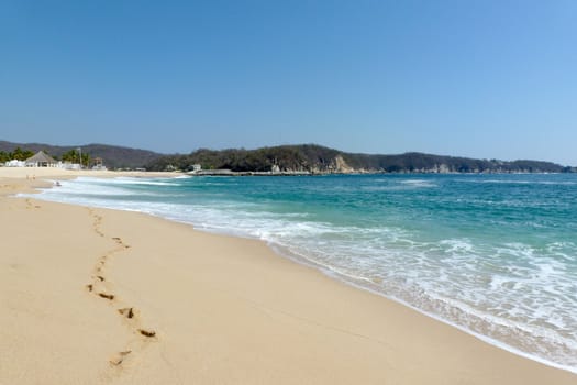 Footprints in the sand of the beach at Chahue, Huatulco, Mexico