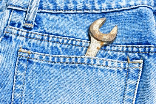 Wrench set in the pocket of grey jeans,focus on