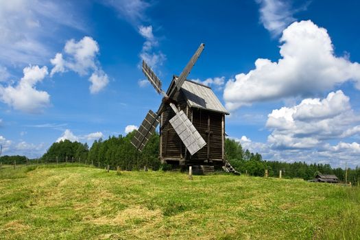 Old windmill under blue sky